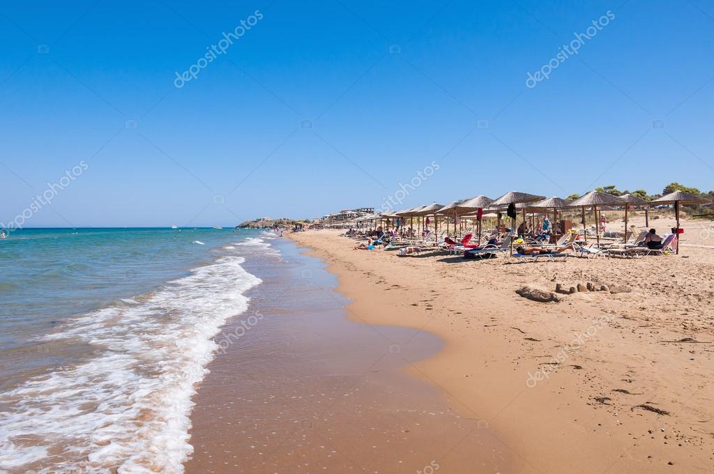 People Sunbathe On The Banana Beach Zakynthos Greece