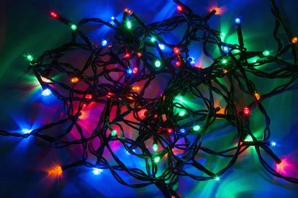 Karácsonyi fények sötét háttér — Stock Fotó