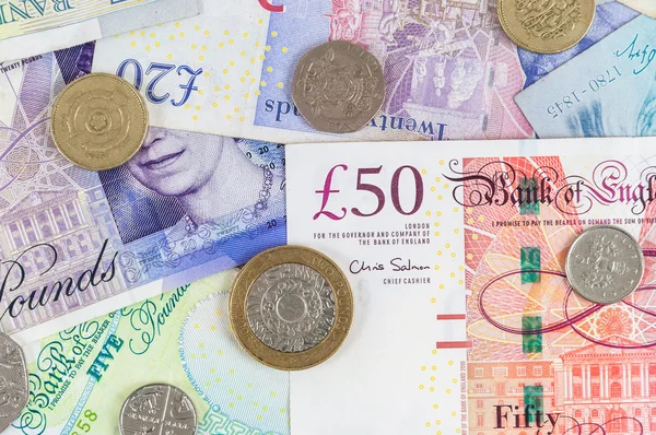 British pounds banknotes and coins background — Stock Photo, Image