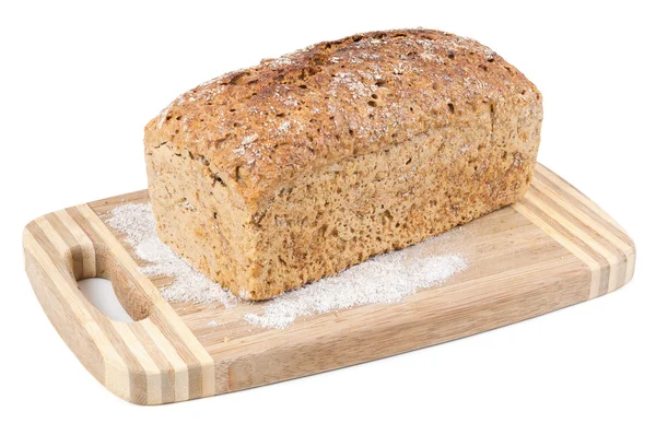 Pão integral em uma tábua de cortar — Fotografia de Stock