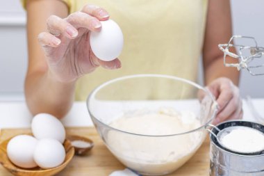 Kahvaltı için ev krepleri için hamur hazırlığı. Masanın üzerindeki buğday unu ve yumurtalar.
