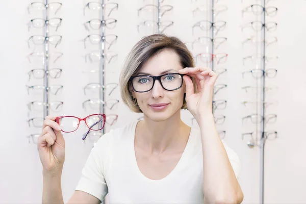 Ung Kvinna Optikaffären Väljer Nya Glasögon Med Optiker Glasögon Förrådet — Stockfoto