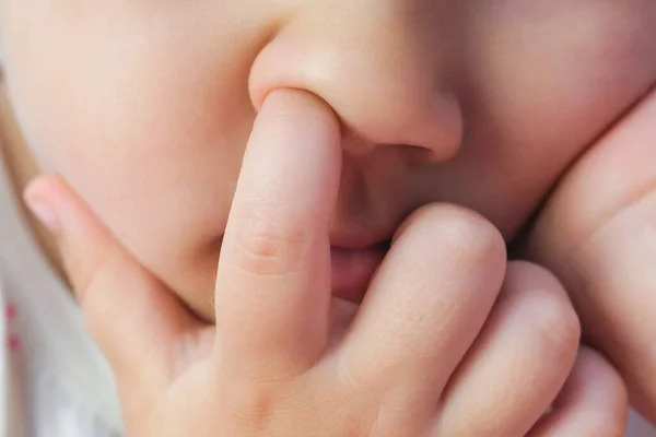 nose picking. Child picking his nose close up