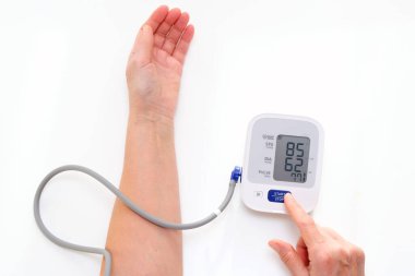 Man measures blood pressure, white background. arterial hypotension. hand and tonometer close up.