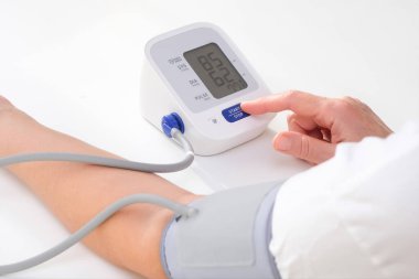 Man measures blood pressure, white background. arterial hypotension. hand and tonometer close up.