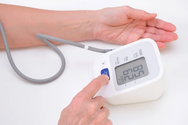 Man Measures Blood Pressure White Background Arterial Hypotension Hand Tonometer — Foto de Stock
