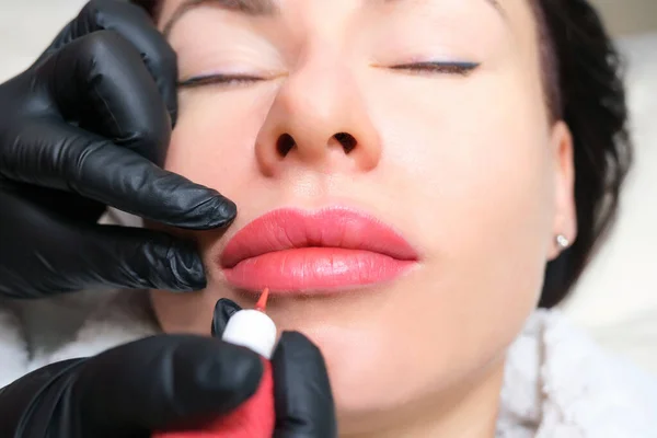 Close up of permanent lip makeup. lip tattoo. Beautiful lips