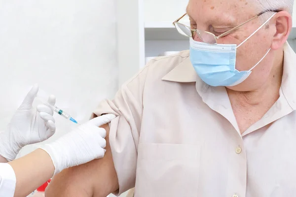 Vaccination of an adult person in a hospital. Healthcare concept, coronavirus vaccine