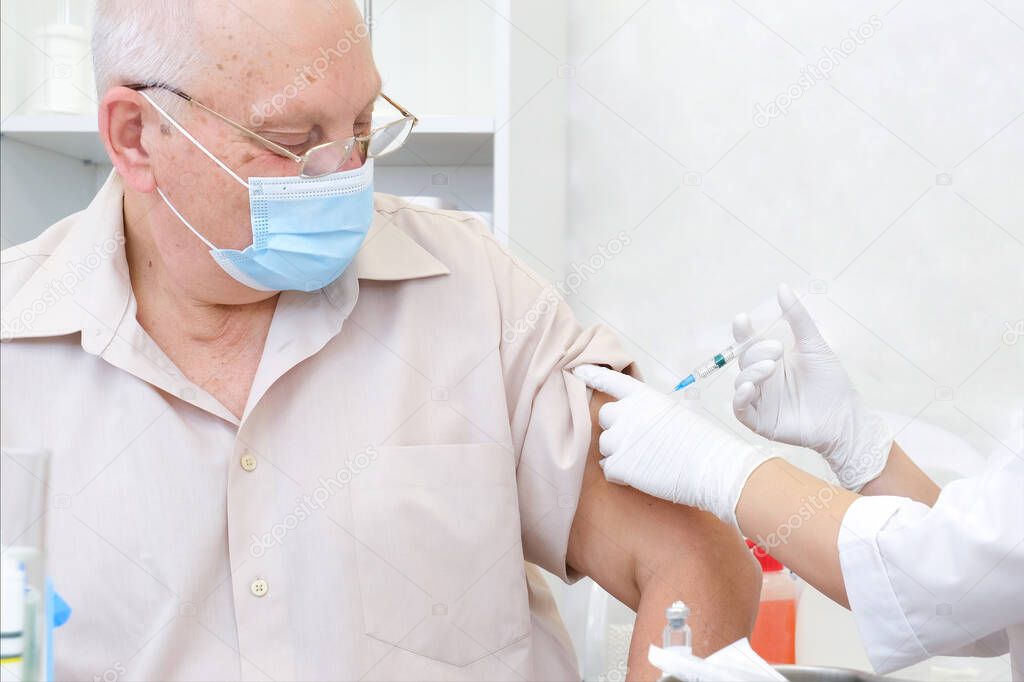 Vaccination of an adult person in a hospital. Healthcare concept, coronavirus vaccine