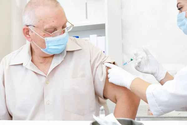 Vaccination of an adult person in a hospital. Healthcare concept, coronavirus vaccine