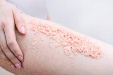 Fırçayla bacaklarına sürtünen genç bir kadın manzarası..