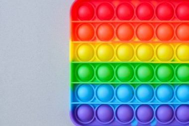 Gökkuşağı oyuncak hareketini boş fotokopi alanının arka planında yap. Gri arkaplan