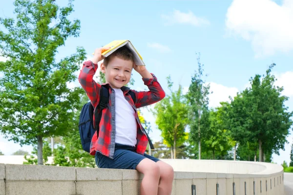 Uno Scolaro Con Libro Testa Come Tetto Sulla Strada Mentre — Foto Stock