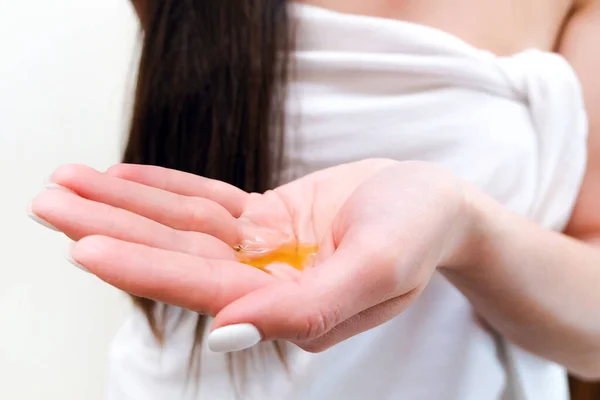 Young Woman Pours Oil Her Palm Hair Skin Care — Stock Photo, Image