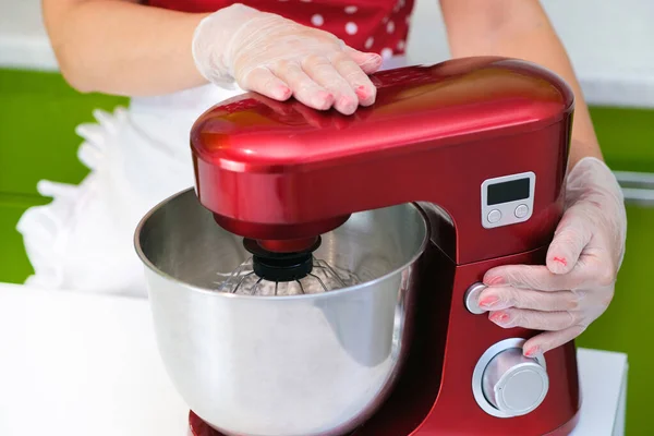 Beaten egg whites until frothy. Whipped egg whites for a meringue. Red stationary mixer, food processor