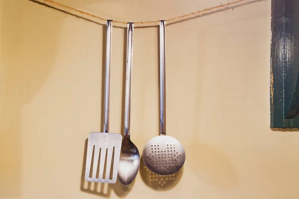 kitchen utensils hanging on wall