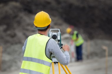 Workers with theodolite clipart