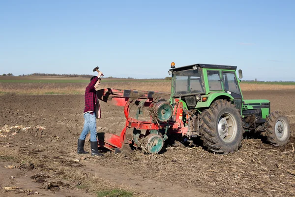 Farmer repairing tractor — Stock Photo, Image