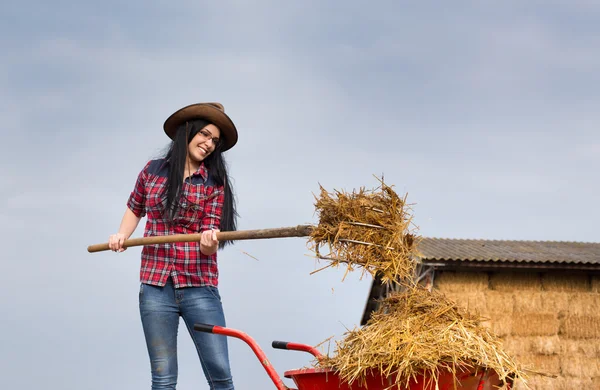 Pretty country woman working with animal manure — Stock Photo, Image