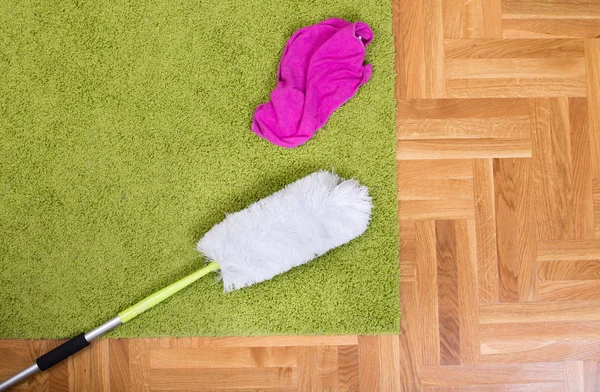 Duster and loth on the carpet — Stock Photo, Image