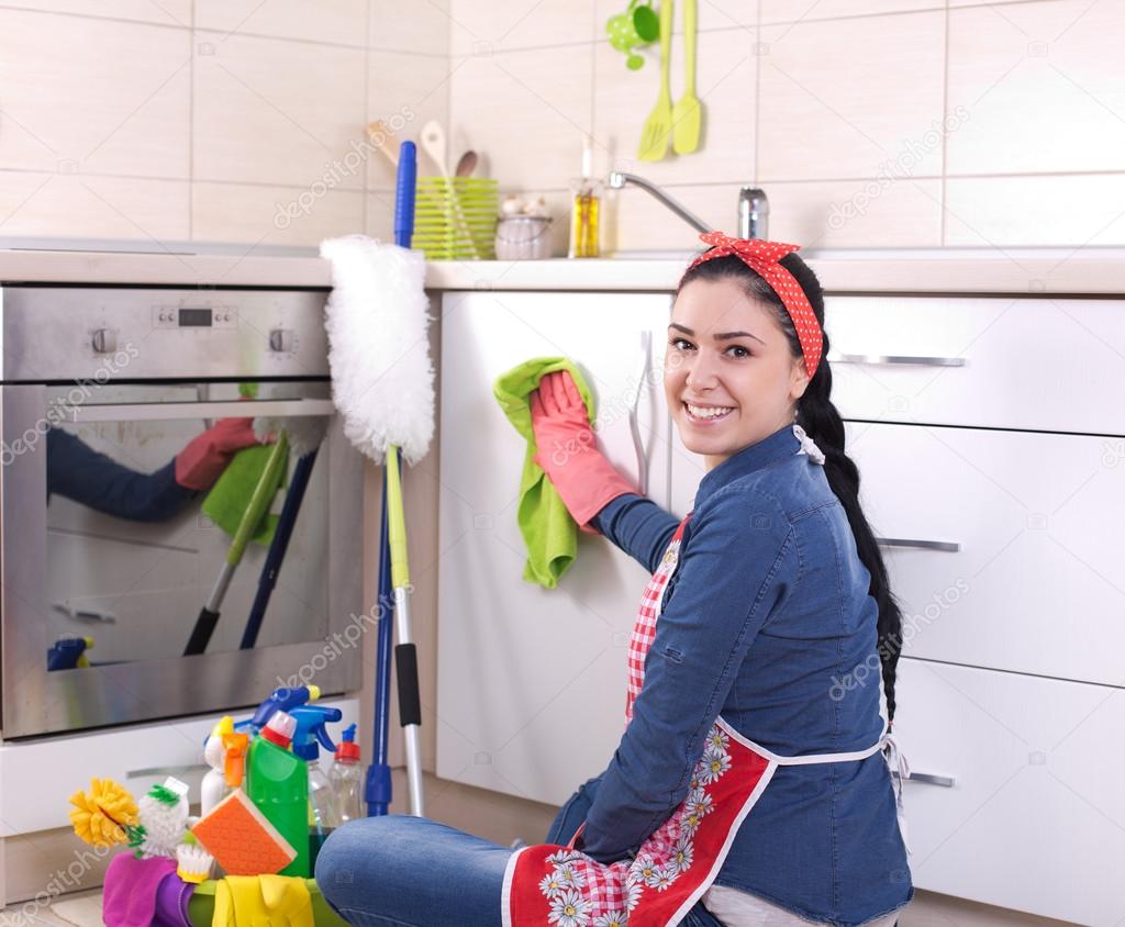 Woman wiping kitchen drawers