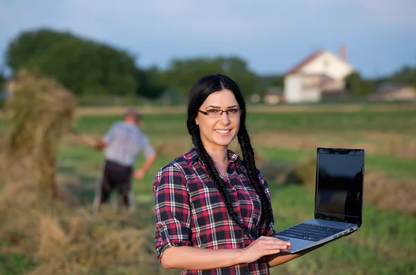 Jordbrukaren flicka med laptop på ranch — Stockfoto