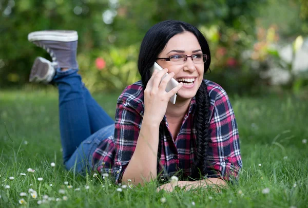 Girl talking on phone on grass