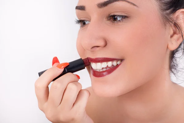 Girl applying red lipstick — Stock Photo, Image