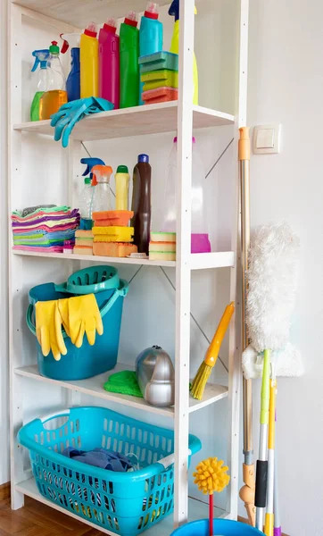 Shelves with cleaning products and tools in pantry