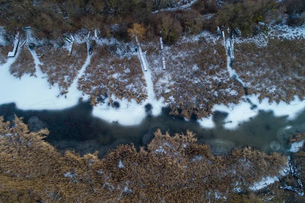 Aerial image on river and coast in winter with snow and ice
