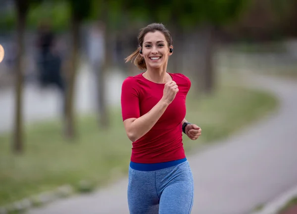 Fit Girl Smiling While Running Outdoors Athlete Exercising While Listening — Photo