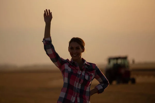 Pretty Young Farmer Woman Waving Hands Front Tractor Field Sunset — Stock Photo, Image