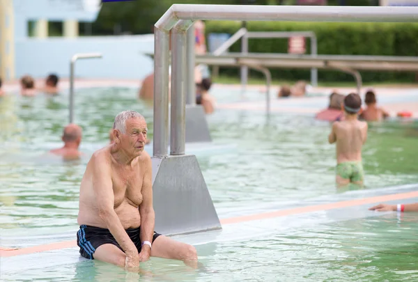 Old man in the pool — Stock Photo, Image