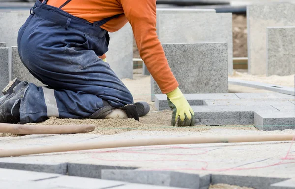 Paver working on knees — Stock Image Paver working on knees Stock Picture