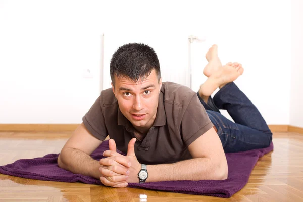 Man lying on the floor on stomach — Stock Photo, Image
