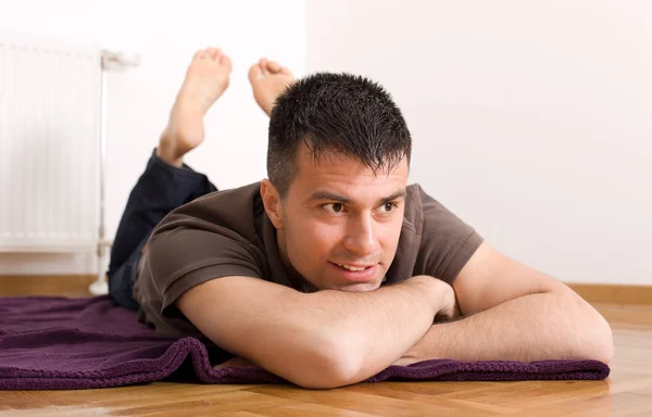 Man lying on stomach on the floor — Stock Photo, Image