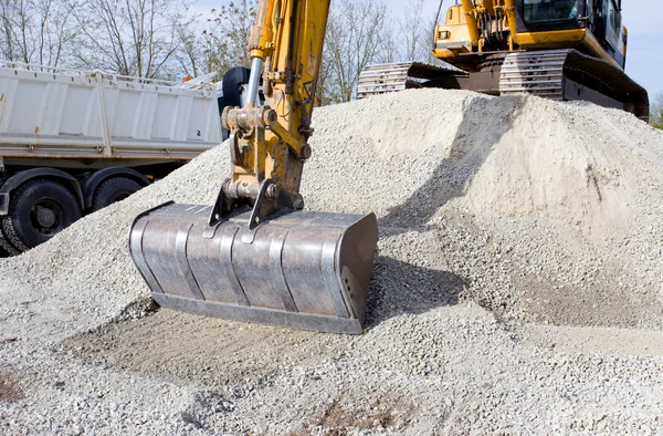 Excavator bucket loading truck — Stock Photo, Image