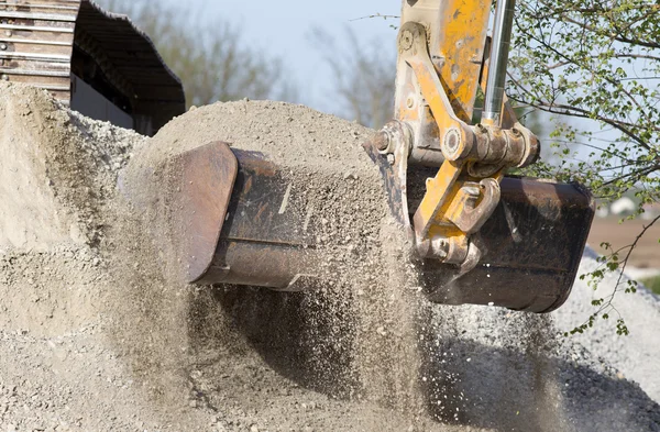 Excavator bucket with gravel — Stock Photo, Image