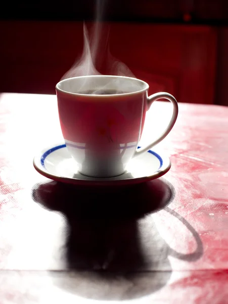 Steaming coffee on the table — Stock Photo, Image