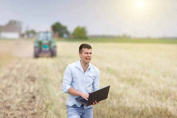 Young farmer yelling in the field — Stock Photo, Image