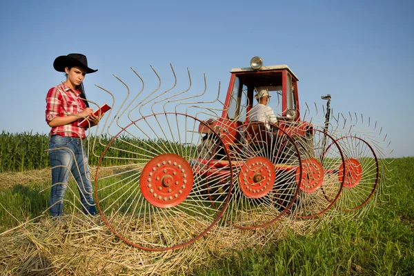 Woman looking at haying rake — Stock Photo, Image
