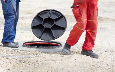 Workers beside manhole clipart