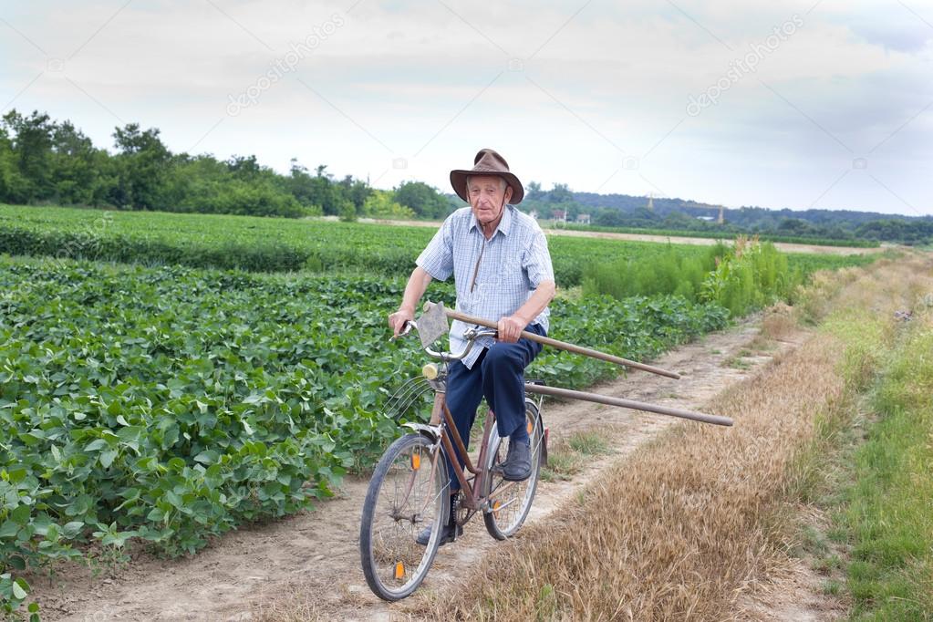 Senior farmer riding a bike