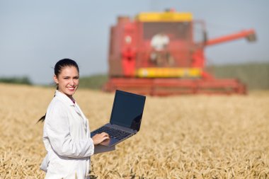 Woman agronomist in wheat field