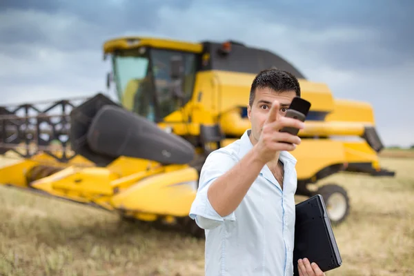 Geschäftsmann mit Laptop und Handy auf dem Feld — Stockfoto