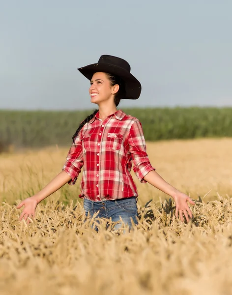 Meisje met cowboy hoed in tarweveld — Stockfoto