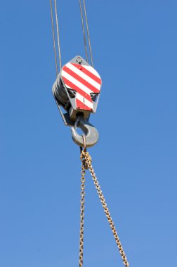 Crane hook against blue sky clipart