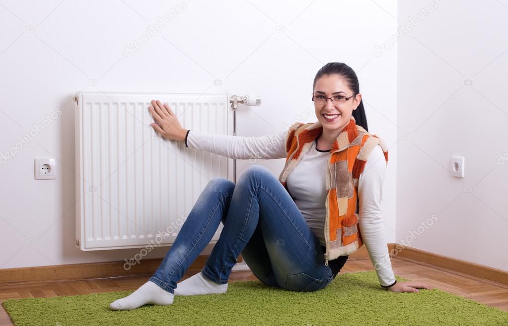 Woman next to warm radiator