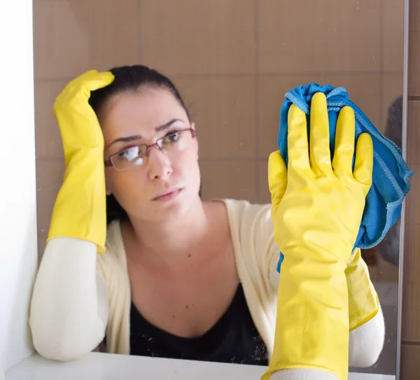 Vrouw schoonmaak badkamerspiegel — Stockfoto