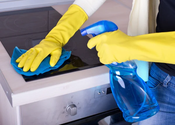 Woman cleaning cooker — Stock Photo, Image